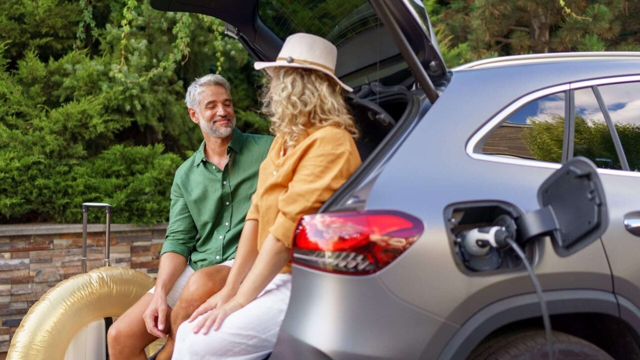 couple sitting in electric vehicle scaled e1691531140929