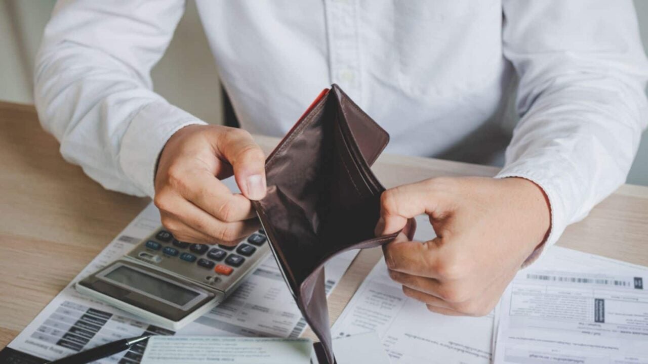 Man holding empty wallet