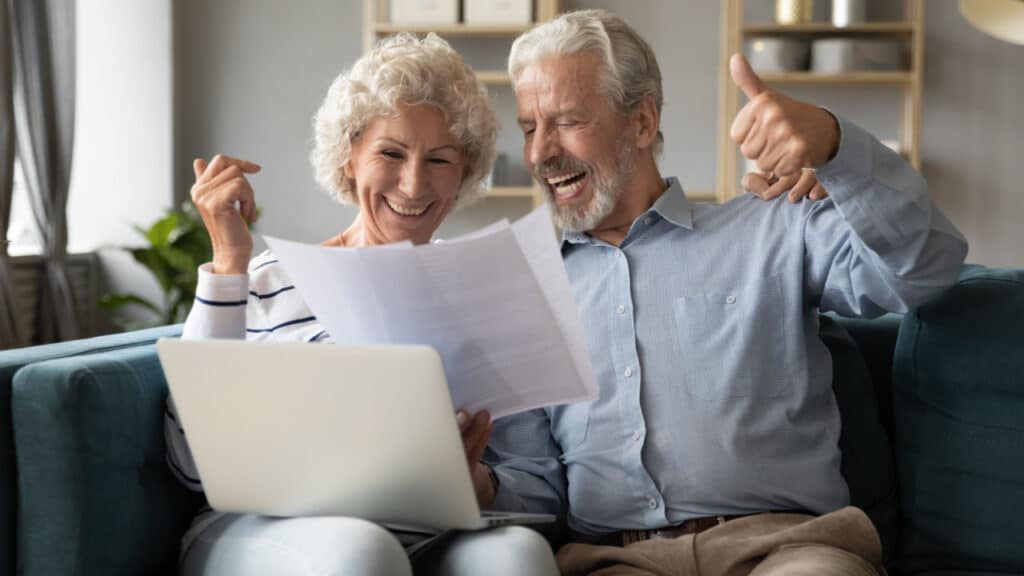 a couple cheers after they pay off their mortgage