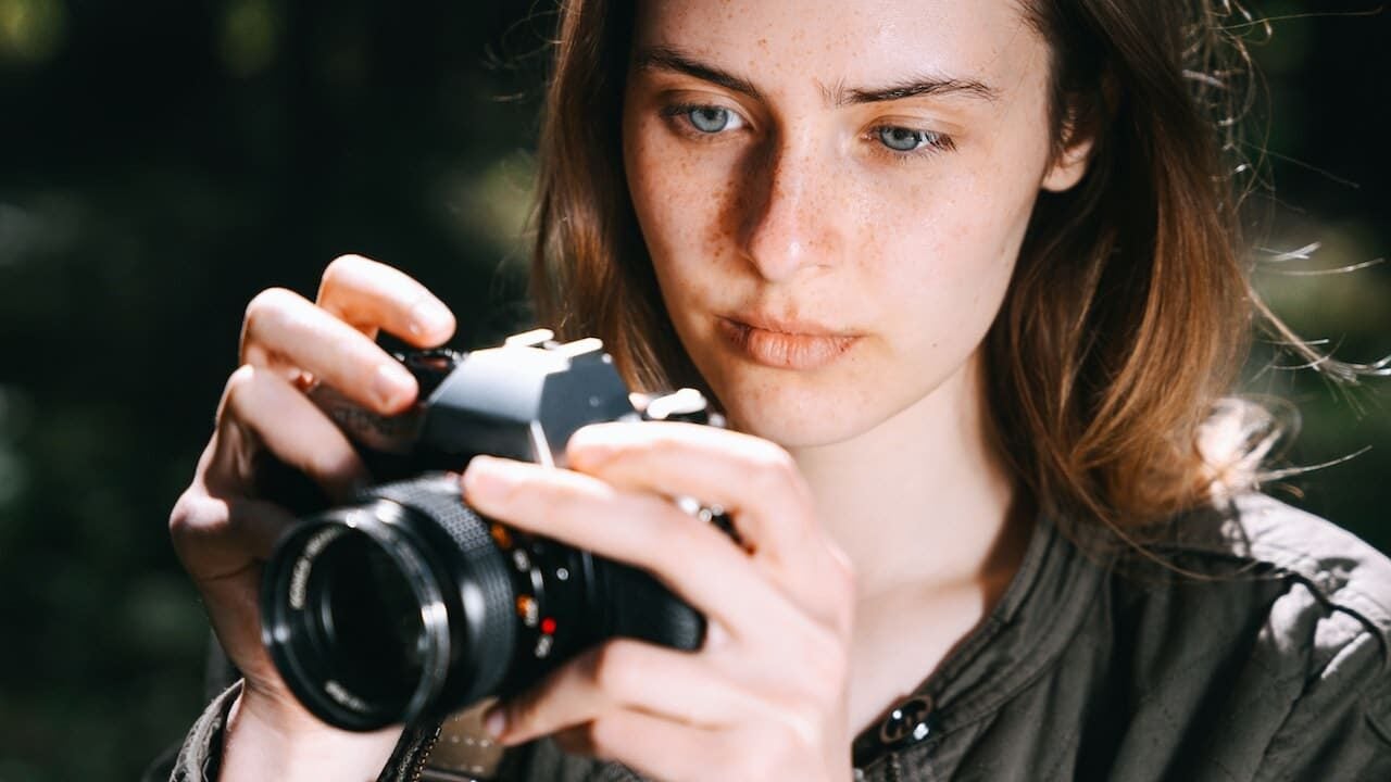 woman taking photo with camera