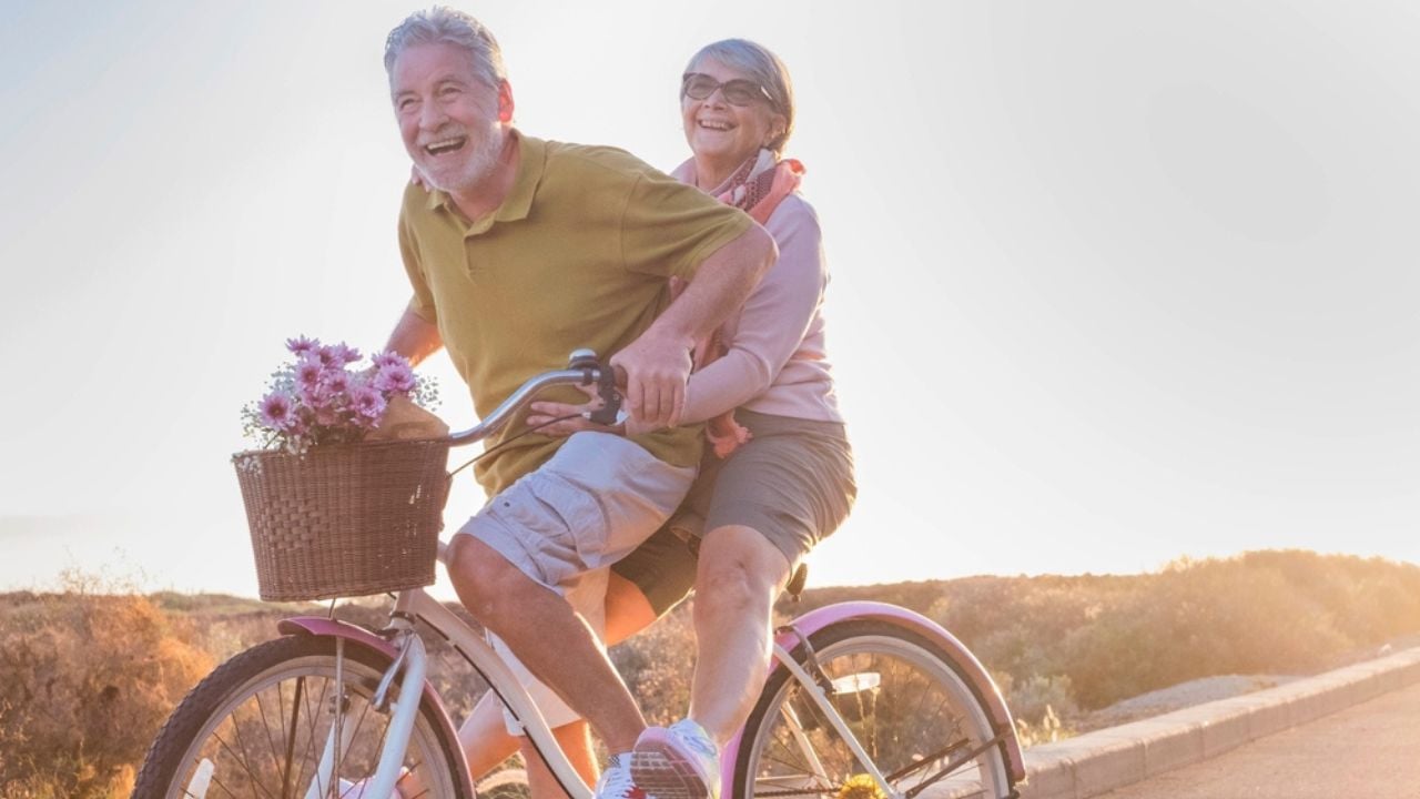 Happy seniors riding a bike