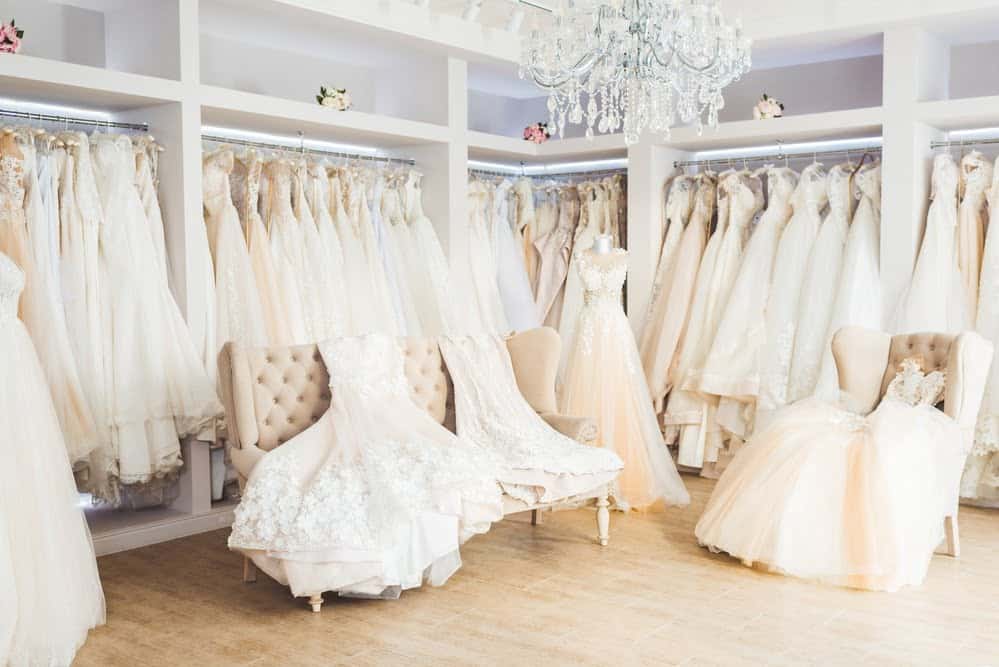 Photo of wedding dresses on a rack in a bridal shop