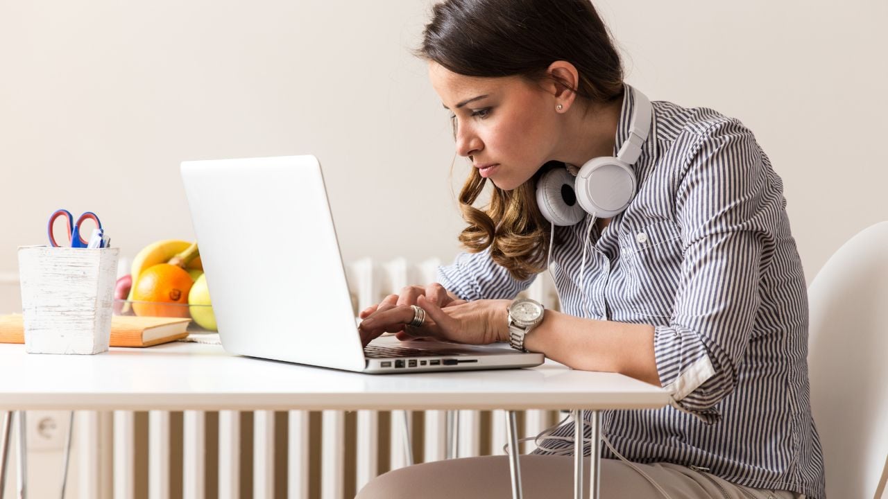 Attractive young woman working on her blog at home.Startup concept.