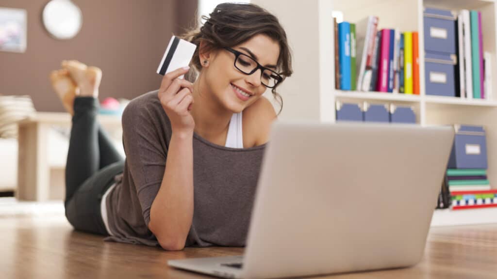 Happy woman doing online shopping at home