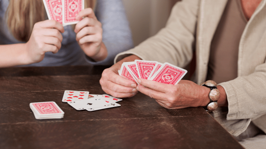 2 player card games - photo of two people's hands playing cards