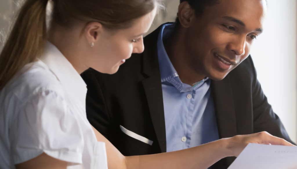 Career Counseling - young couple talking over documents